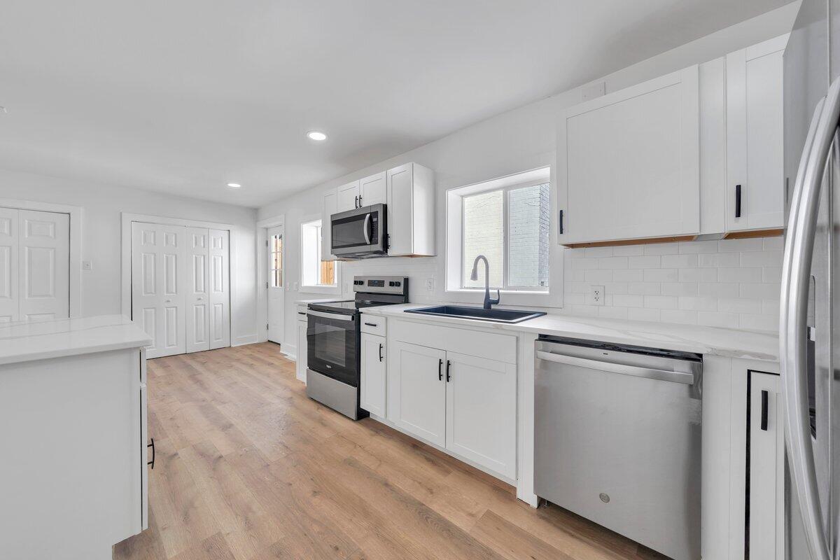 3808 Oldtown Road Shawsville, VA 24162 - Photo 14 of 50 a kitchen with white cabinets and appliances