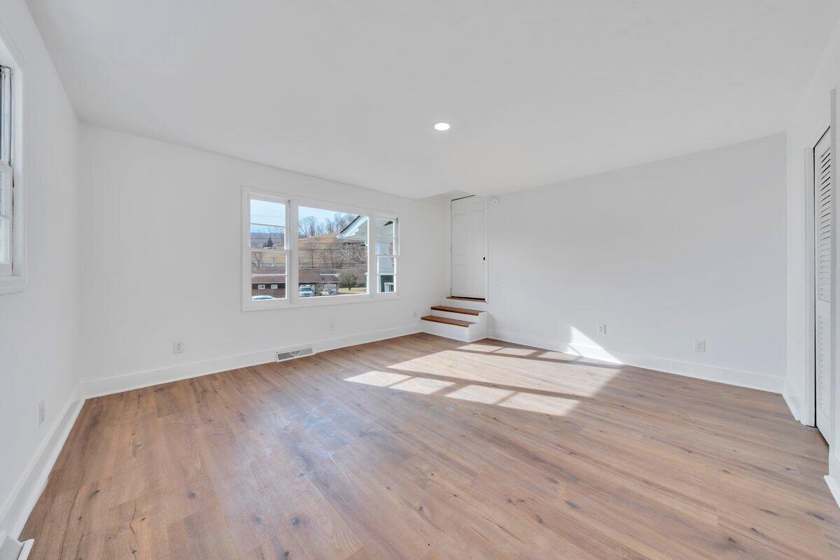 3808 Oldtown Road Shawsville, VA 24162 - Photo 21 of 50 a view of empty room with wooden floor and fan