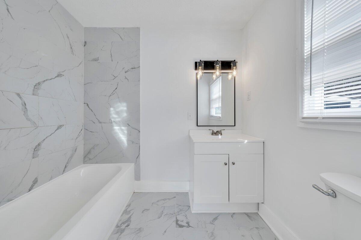 3808 Oldtown Road Shawsville, VA 24162 - Photo 24 of 50 a bathroom with a bathtub sink and mirror