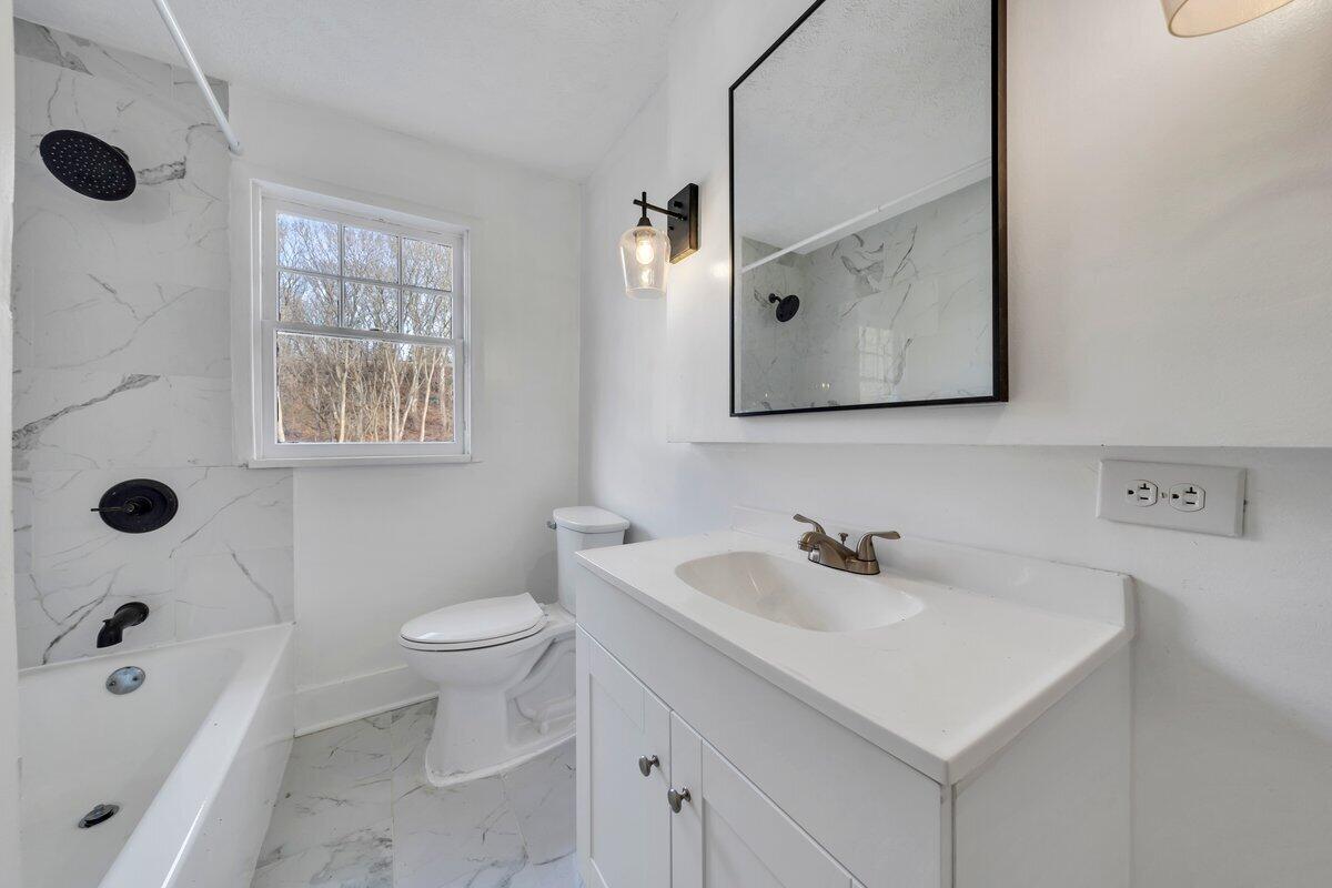 3808 Oldtown Road Shawsville, VA 24162 - Photo 30 of 50 a bathroom with a sink a toilet and shower