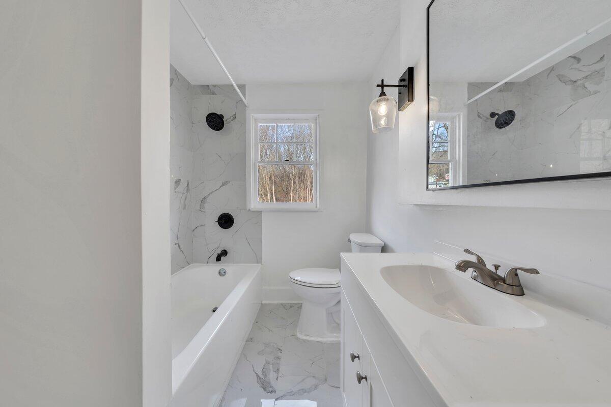 3808 Oldtown Road Shawsville, VA 24162 - Photo 31 of 50 a bathroom with a tub sink toilet and mirror