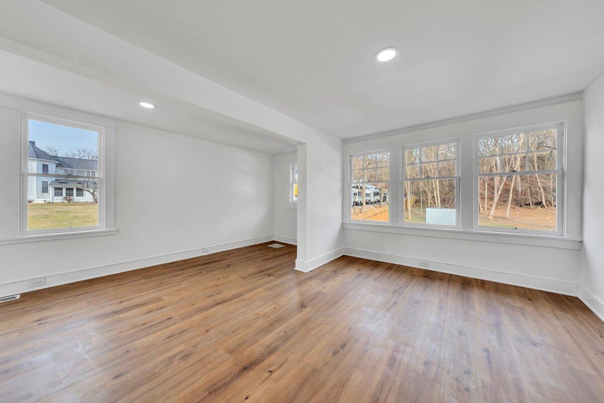 3808 Oldtown Road Shawsville, VA 24162 - Photo 33 of 50 a view of an empty room with wooden floor and a window