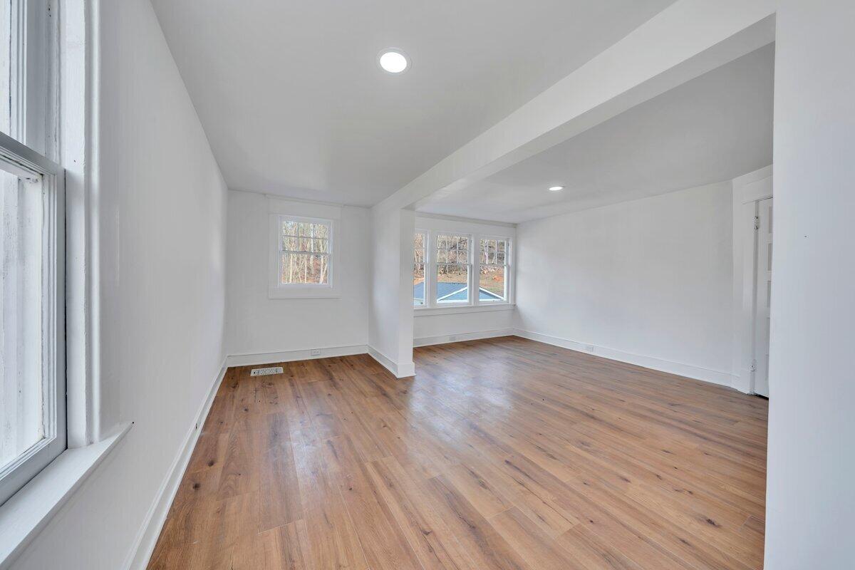 3808 Oldtown Road Shawsville, VA 24162 - Photo 35 of 50 an empty room with wooden floor and windows