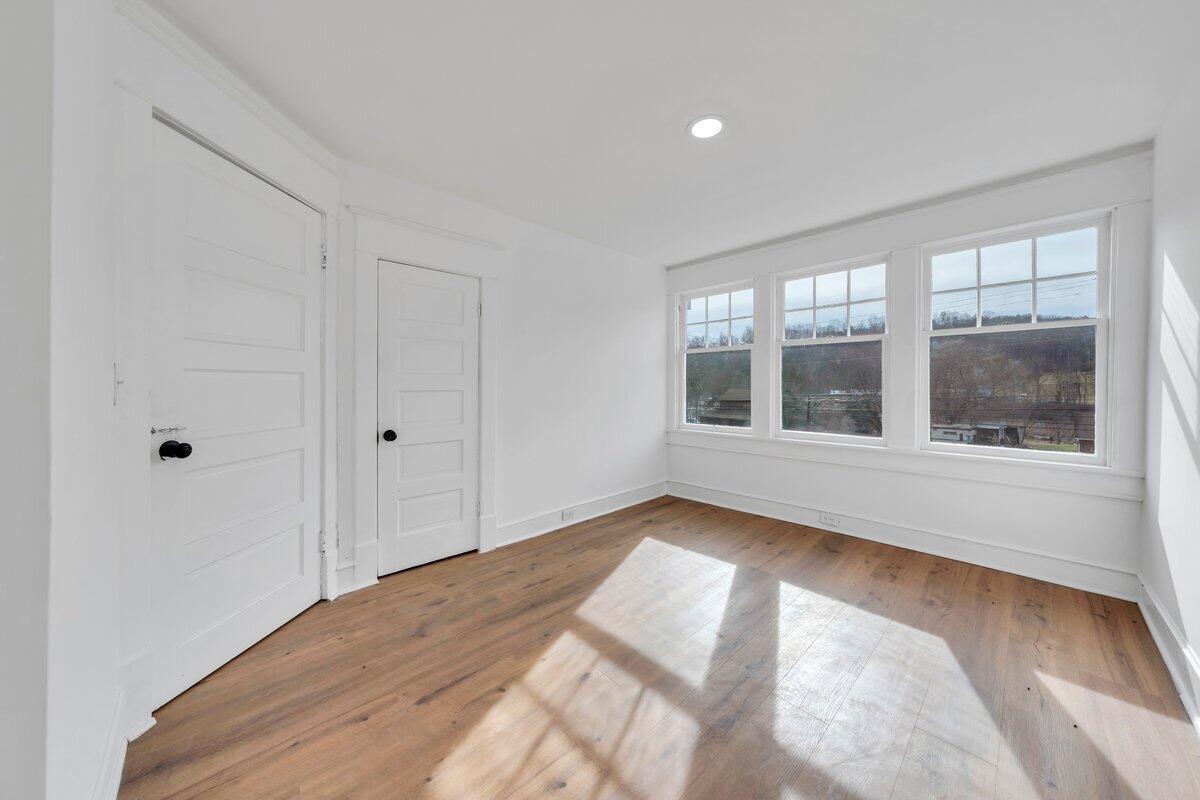 3808 Oldtown Road Shawsville, VA 24162 - Photo 36 of 50 a view of an empty room with a window and wooden floor