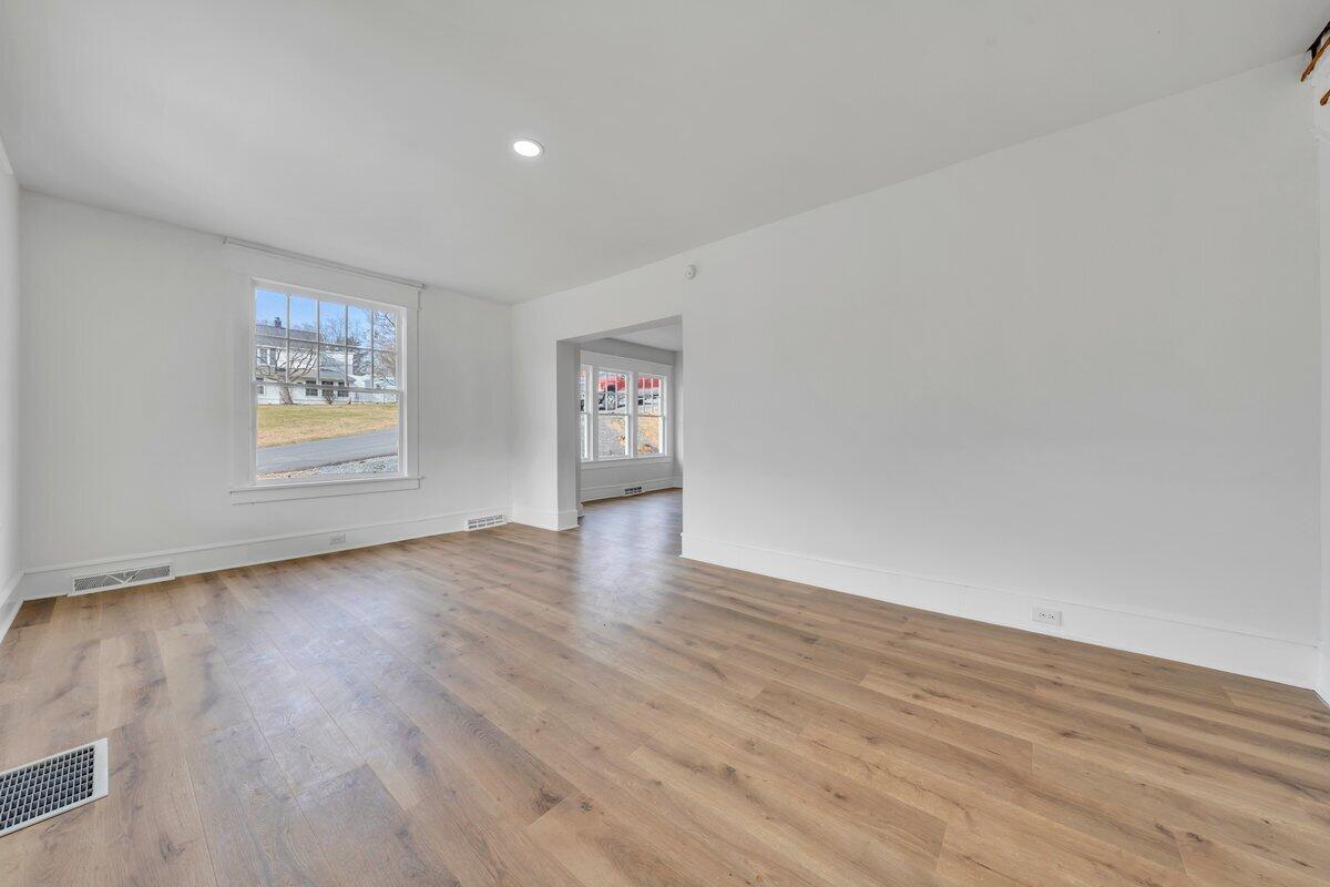 3808 Oldtown Road Shawsville, VA 24162 - Photo 4 of 50 an empty room with wooden floor and windows