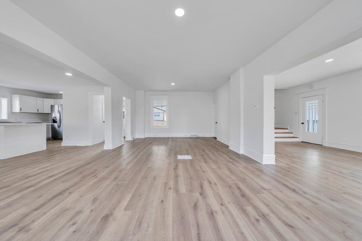 3808 Oldtown Road Shawsville, VA 24162 - Photo 7 of 50 a view of empty room with wooden floor and kitchen