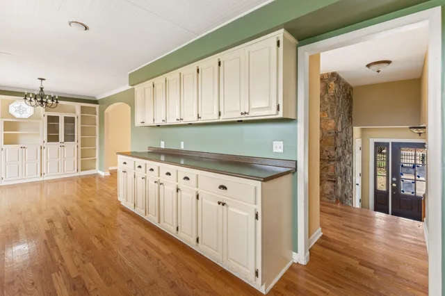 a kitchen with cabinets a sink and wooden floor
