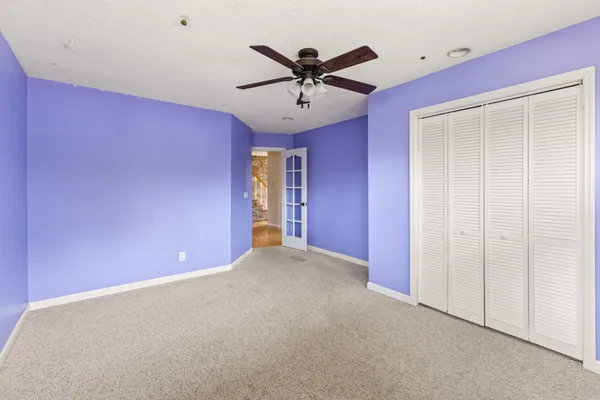 a view of an empty room with a ceiling fan