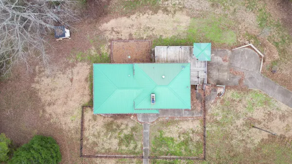 a view of a yard with plants and a wall of