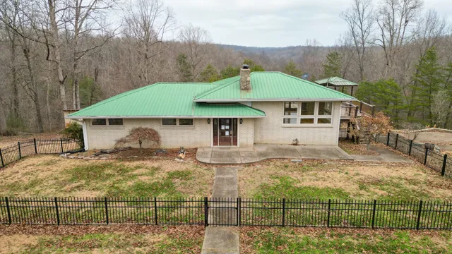 a view of a house with a wooden fence
