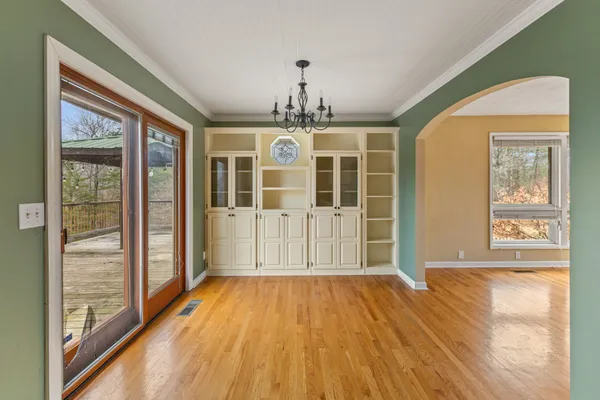 a view of a room with wooden floor and windows