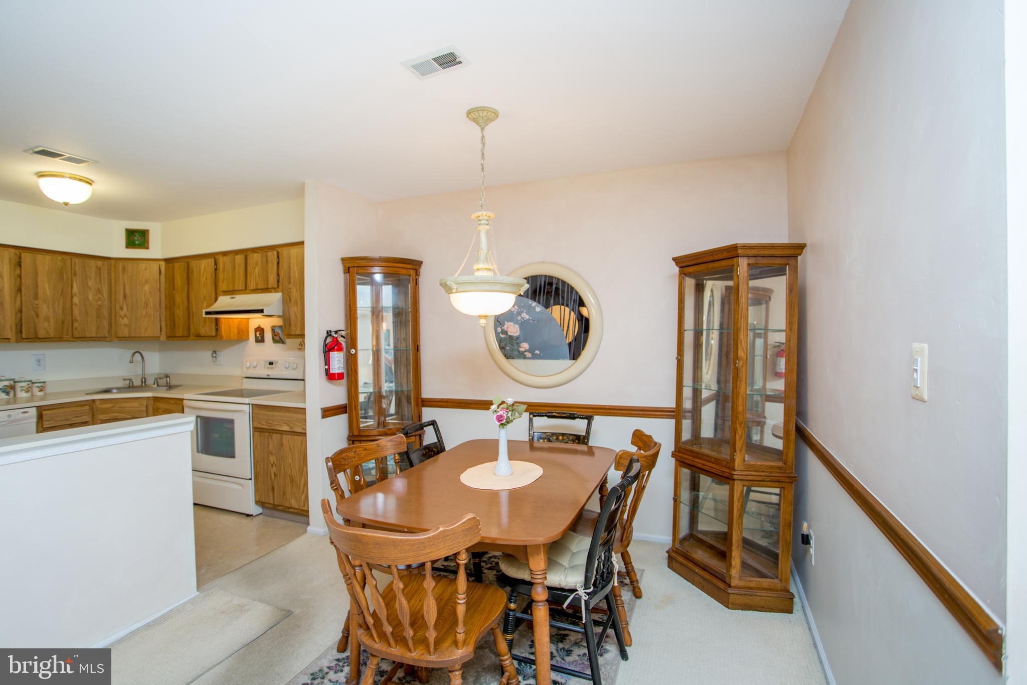 60 B Sumac Court Mount Laurel, NJ 08054 - Photo 13 of 42 a kitchen with a dining table and chairs