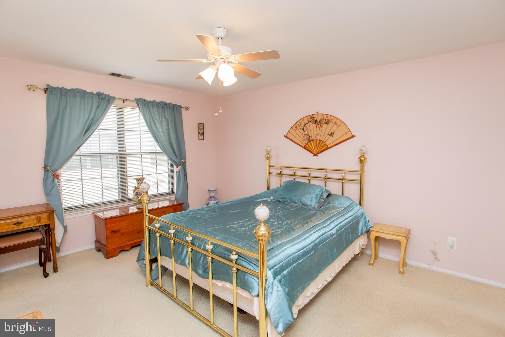 60 B Sumac Court Mount Laurel, NJ 08054 - Photo 19 of 42 a bedroom with a bed a chandelier and a window