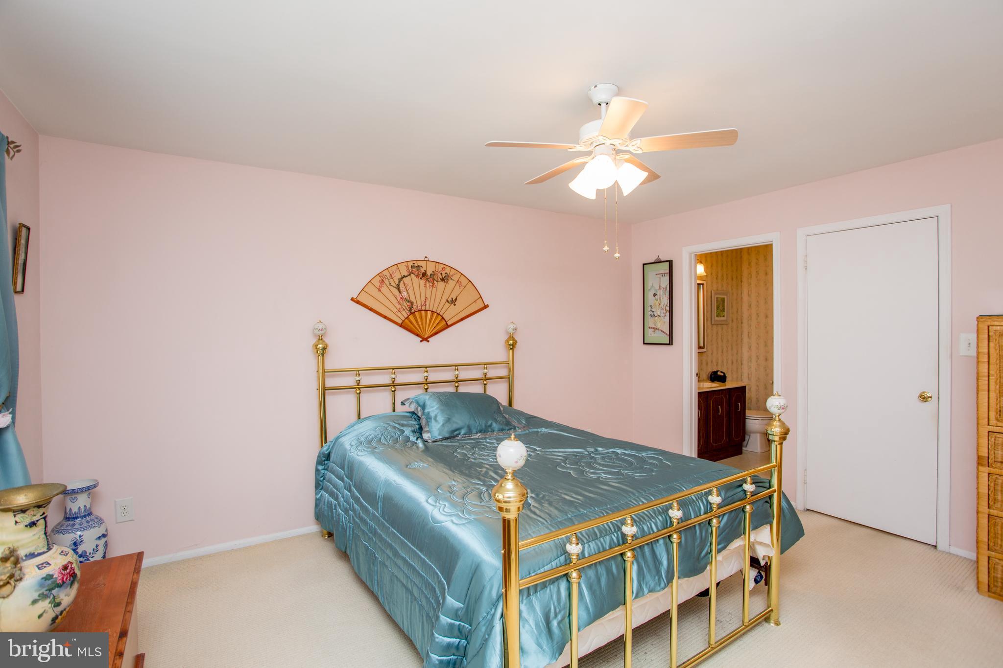 60 B Sumac Court Mount Laurel, NJ 08054 - Photo 20 of 42 a bedroom with a bed and a chandelier