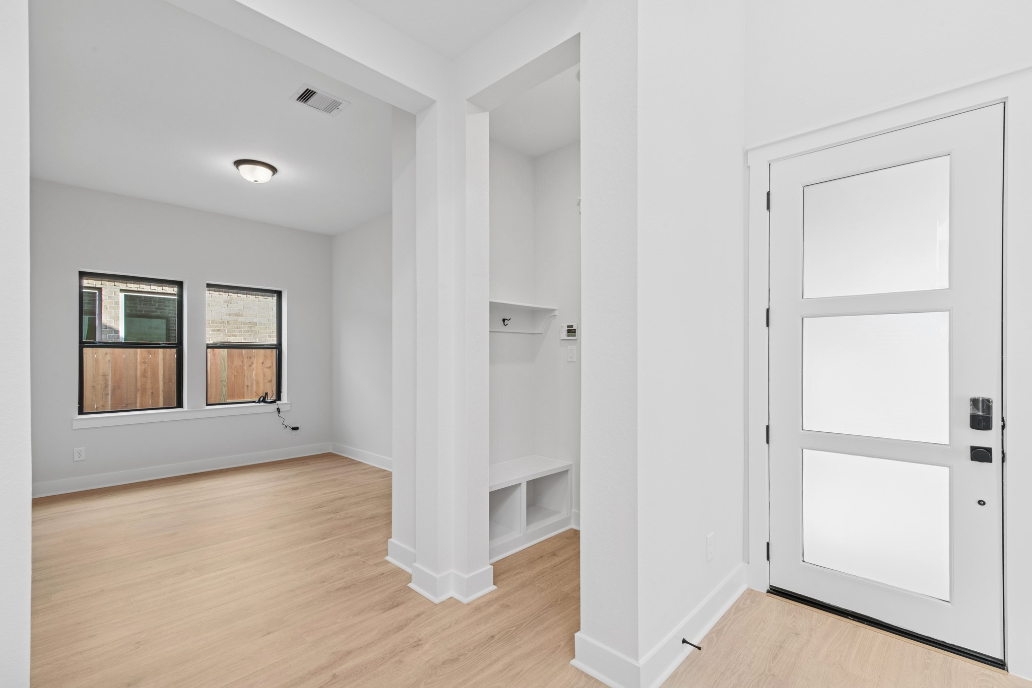 8751 Mancos Valley Porter, TX 77365 - Photo 13 of 48 a view of an empty room with wooden floor and windows