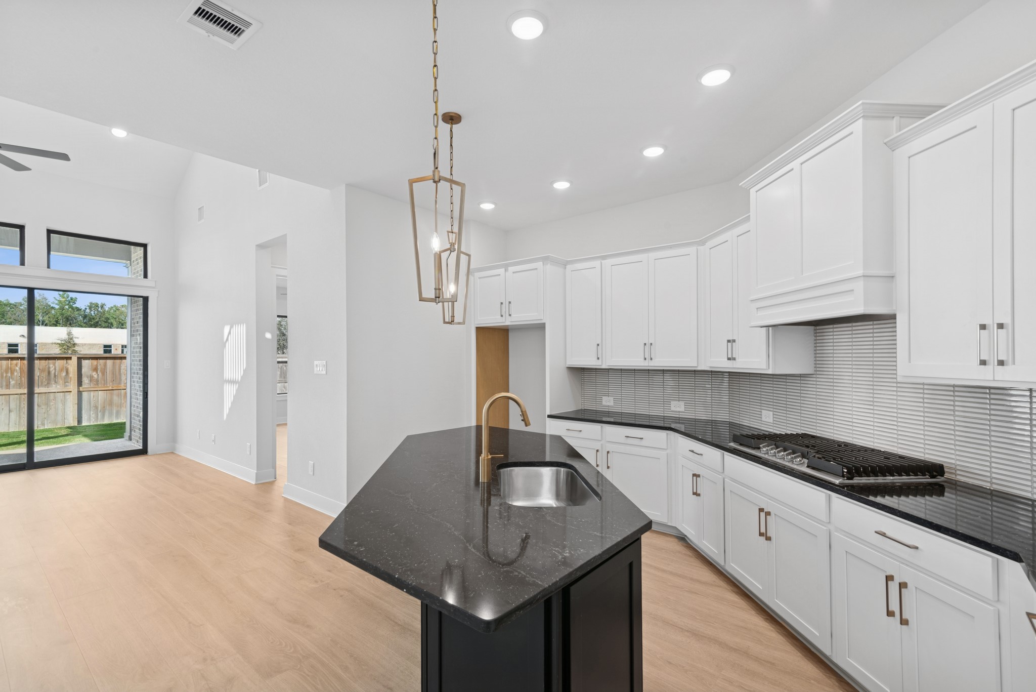 8751 Mancos Valley Porter, TX 77365 - Photo 20 of 48 a kitchen with kitchen island granite countertop a sink a counter top space appliances and cabinets