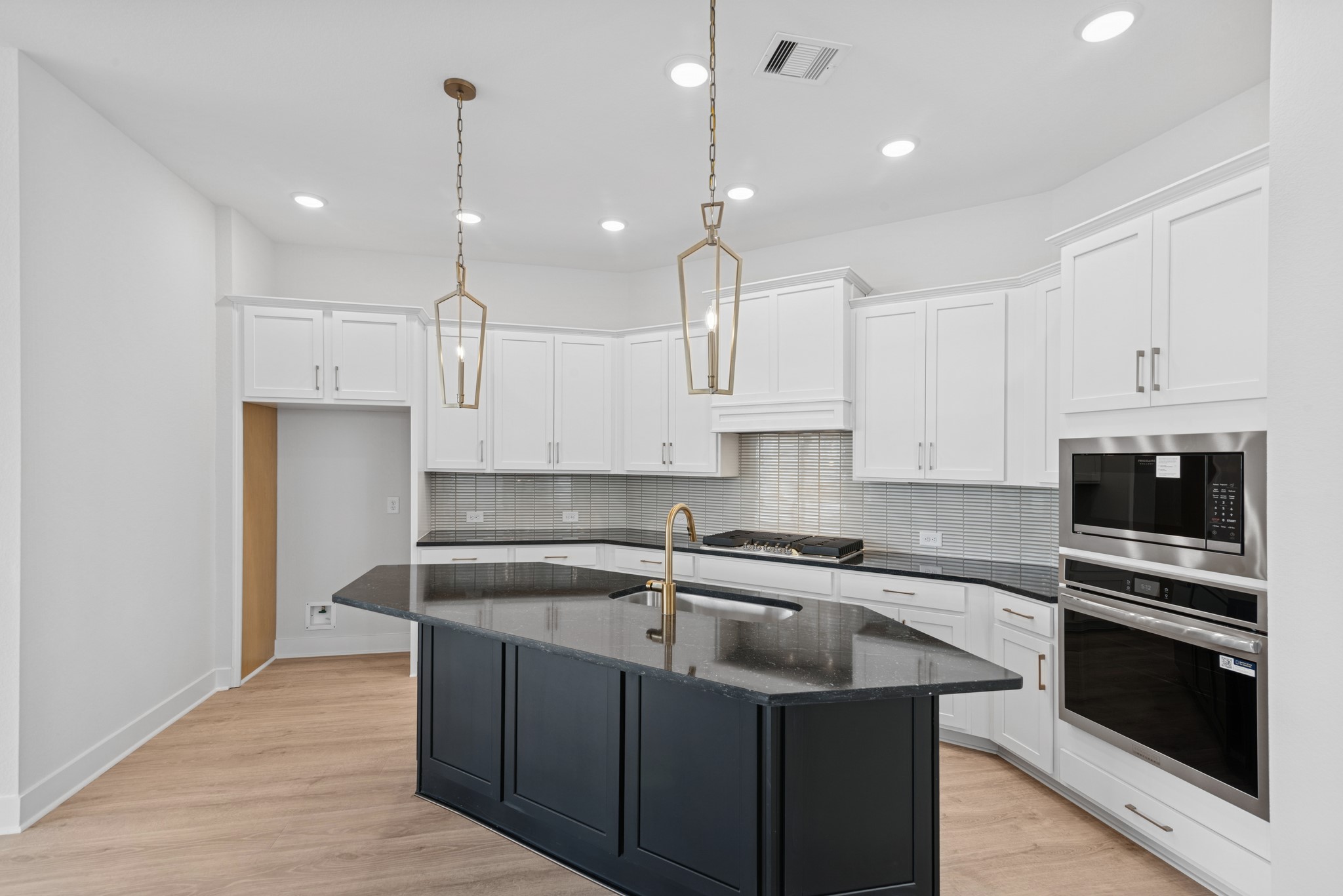 8751 Mancos Valley Porter, TX 77365 - Photo 21 of 48 a kitchen with kitchen island a sink stainless steel appliances and cabinets