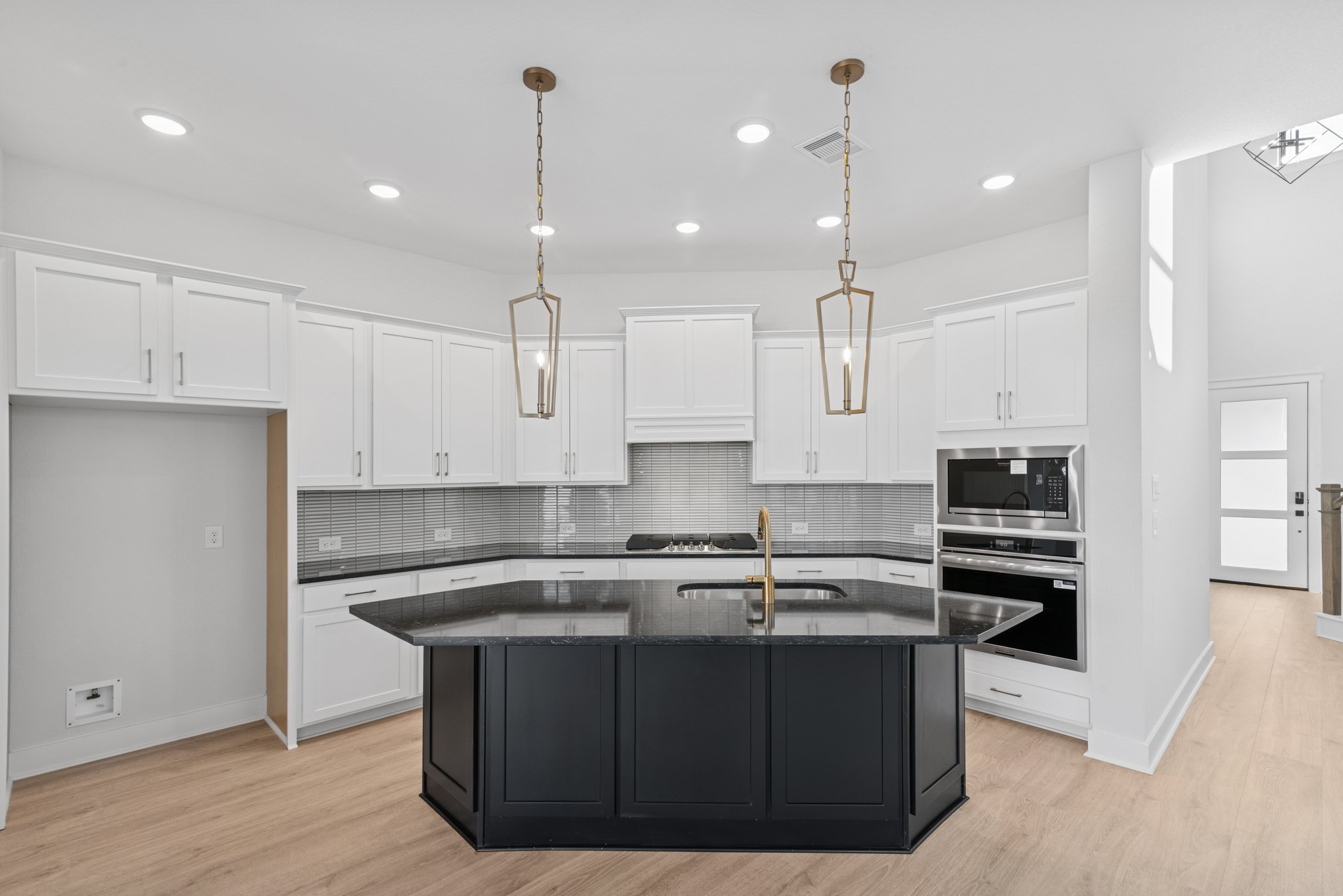 8751 Mancos Valley Porter, TX 77365 - Photo 22 of 48 a kitchen with kitchen island a sink stainless steel appliances and cabinets