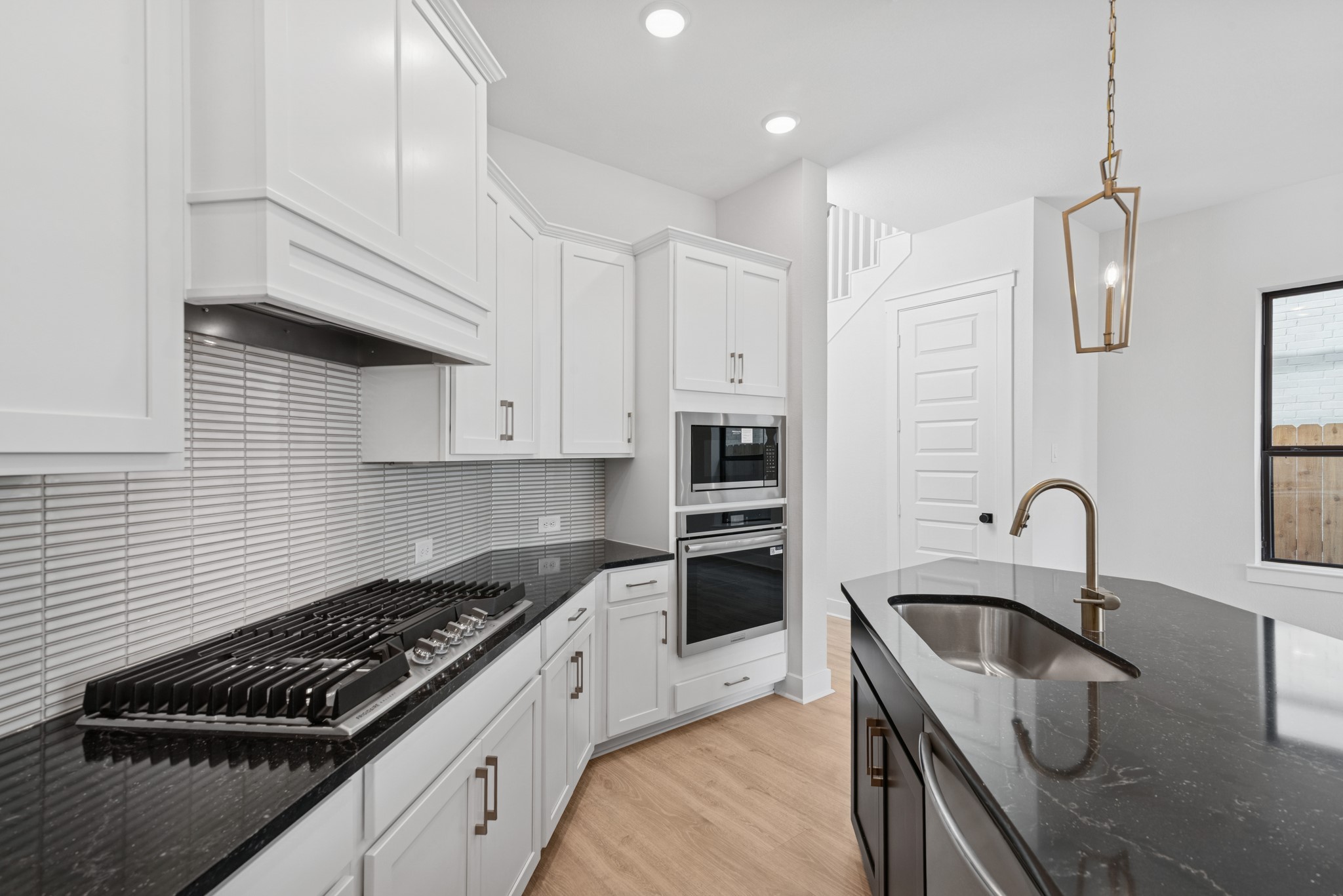 8751 Mancos Valley Porter, TX 77365 - Photo 25 of 48 a kitchen with granite countertop a sink stainless steel appliances and cabinets