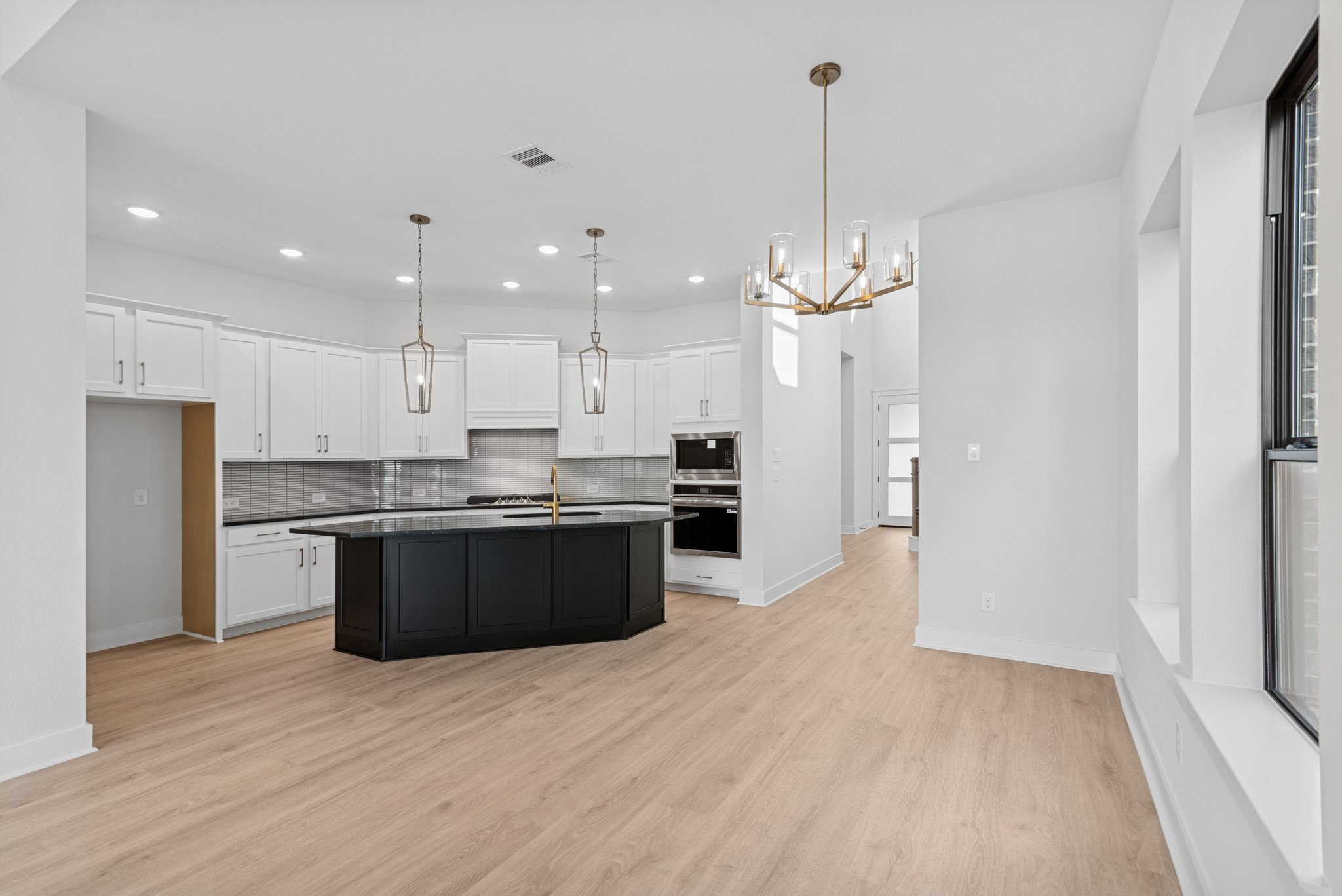 8751 Mancos Valley Porter, TX 77365 - Photo 27 of 48 a large kitchen with kitchen island a sink dishwasher a refrigerator and a stove with wooden floor