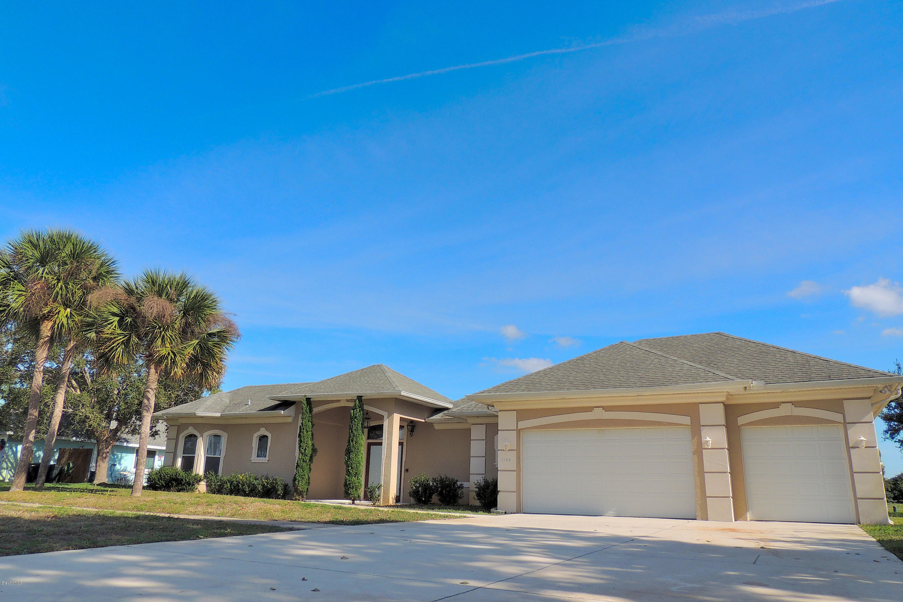 1120 Riviera Drive Northeast Palm Bay, FL 32905 - Photo 2 of 44 a front view of a house with a yard