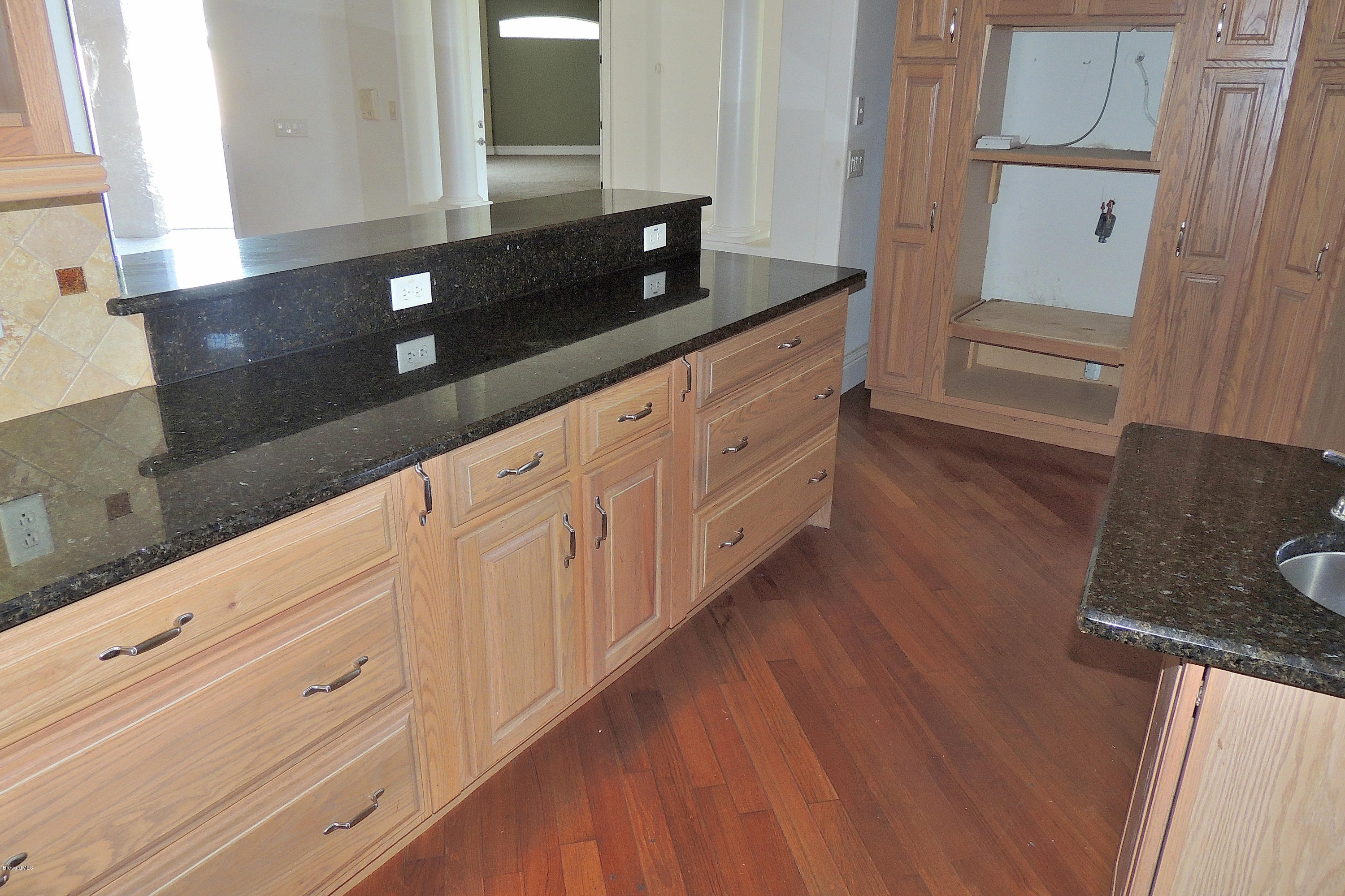 1120 Riviera Drive Northeast Palm Bay, FL 32905 - Photo 13 of 44 a kitchen with granite countertop white cabinets and sink