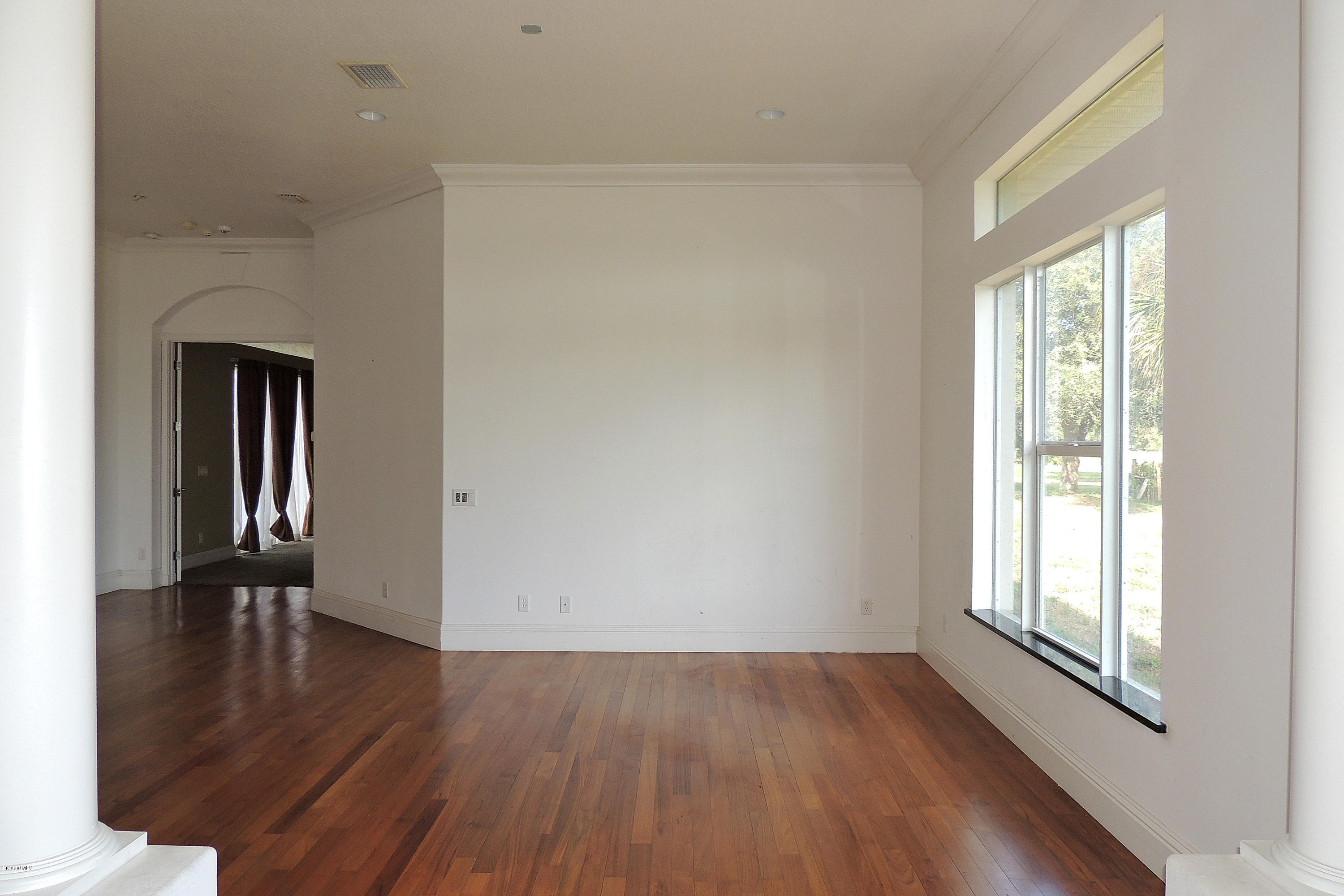 1120 Riviera Drive Northeast Palm Bay, FL 32905 - Photo 14 of 44 a view of empty room with wooden floor and fan