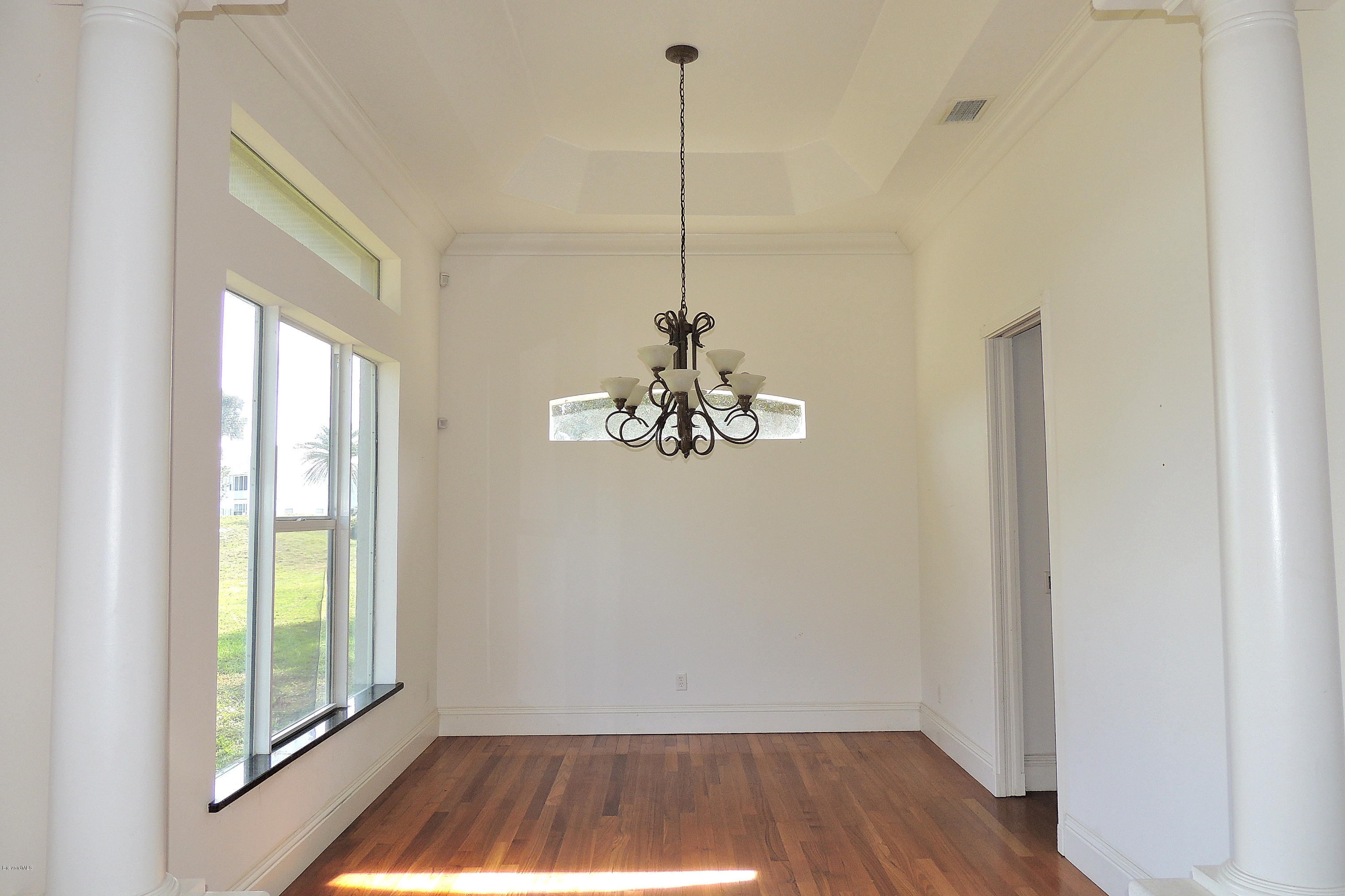 1120 Riviera Drive Northeast Palm Bay, FL 32905 - Photo 15 of 44 a view of a hallway with a chandelier