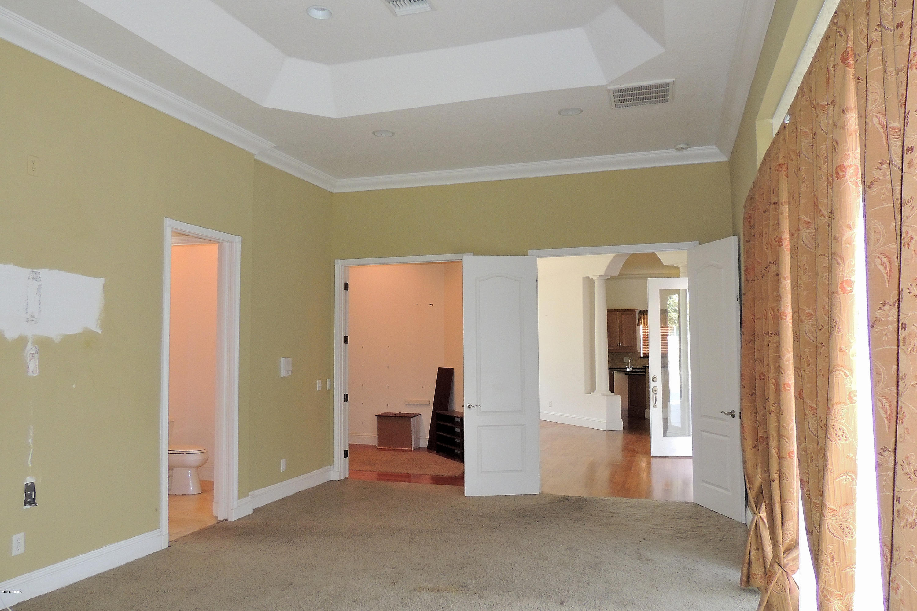 1120 Riviera Drive Northeast Palm Bay, FL 32905 - Photo 21 of 44 an empty room with closet and mirrors