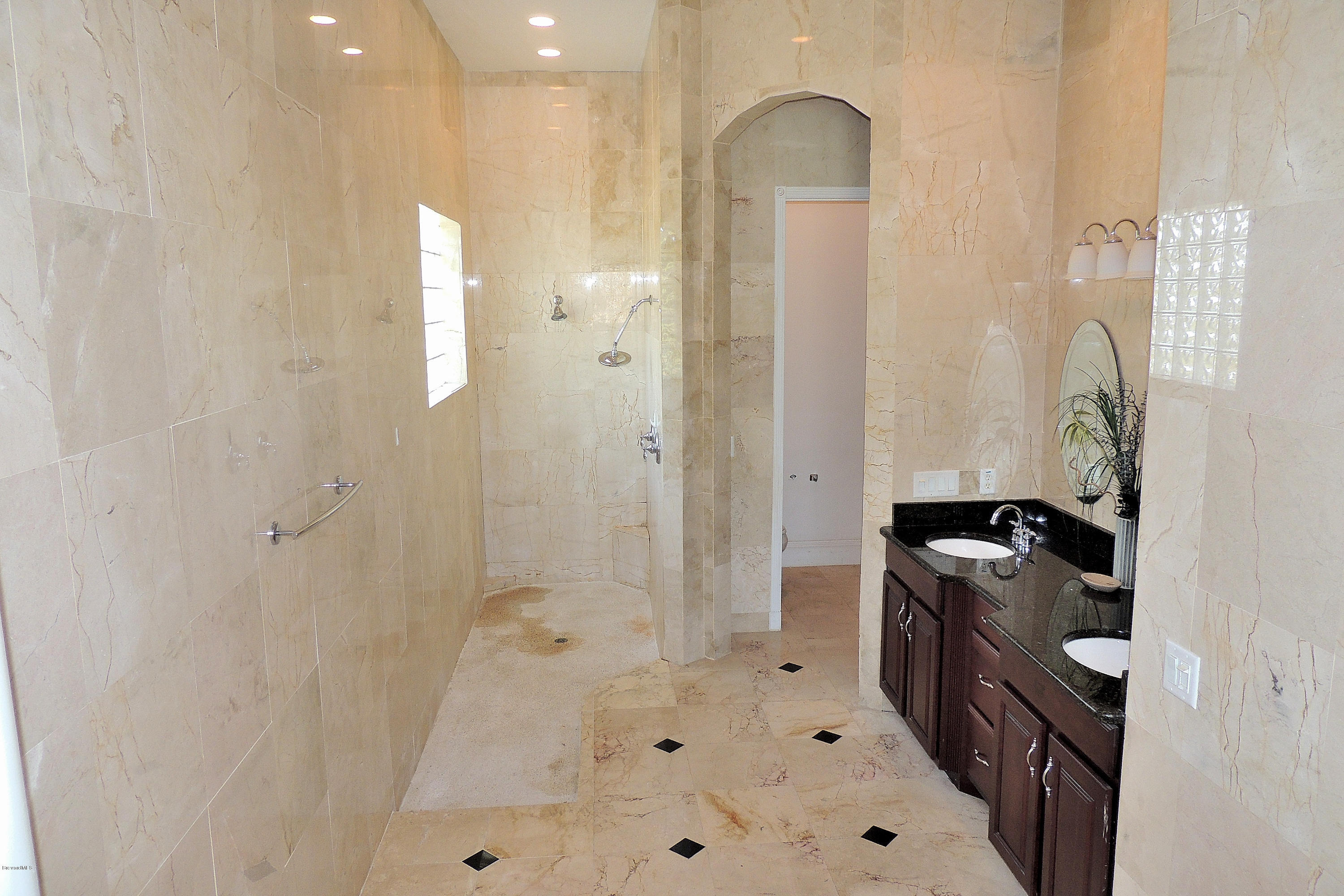 1120 Riviera Drive Northeast Palm Bay, FL 32905 - Photo 25 of 44 a bathroom with a bathtub sink and mirror