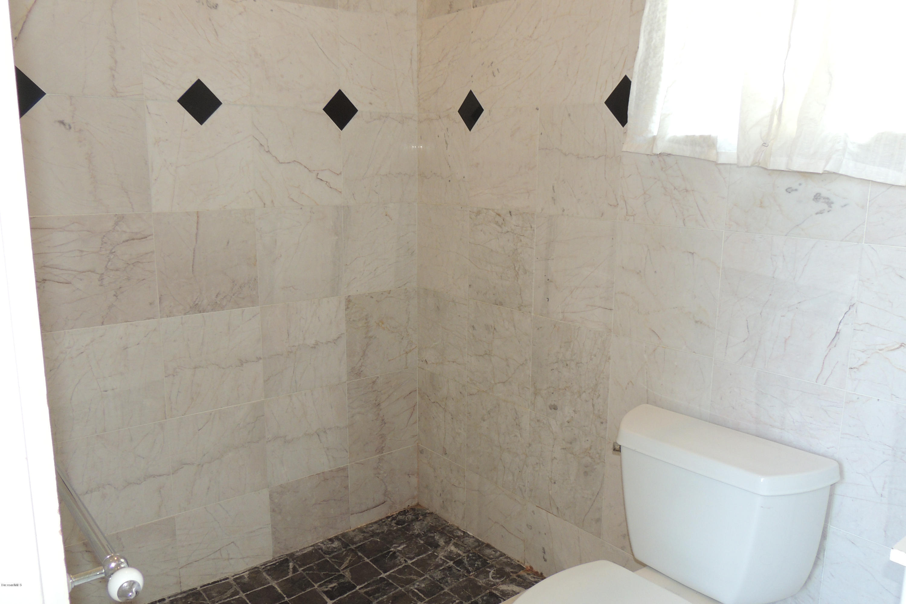 1120 Riviera Drive Northeast Palm Bay, FL 32905 - Photo 29 of 44 a bathroom with a toilet and a shower