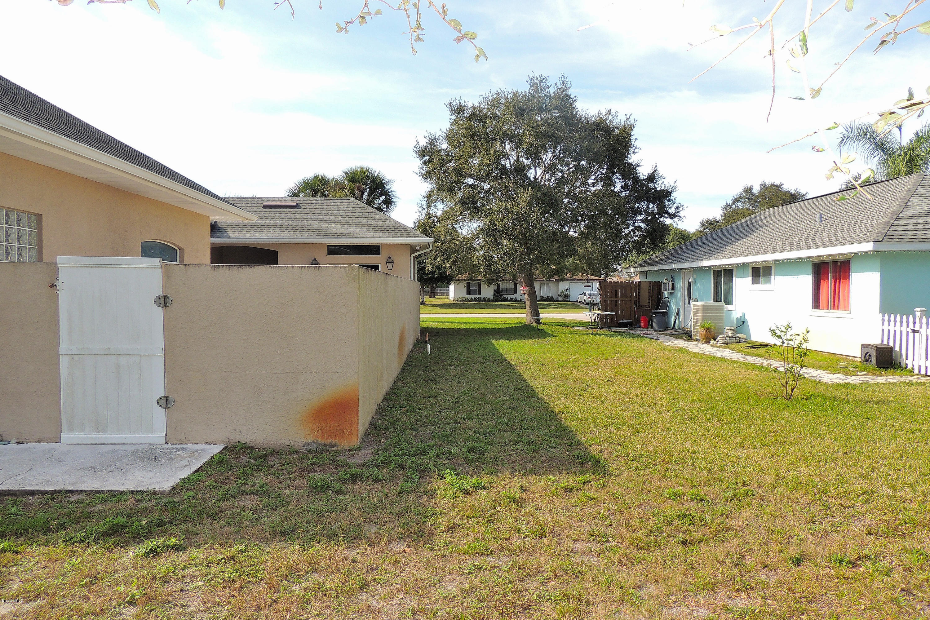 1120 Riviera Drive Northeast Palm Bay, FL 32905 - Photo 41 of 44 a view of a house with a yard and garage