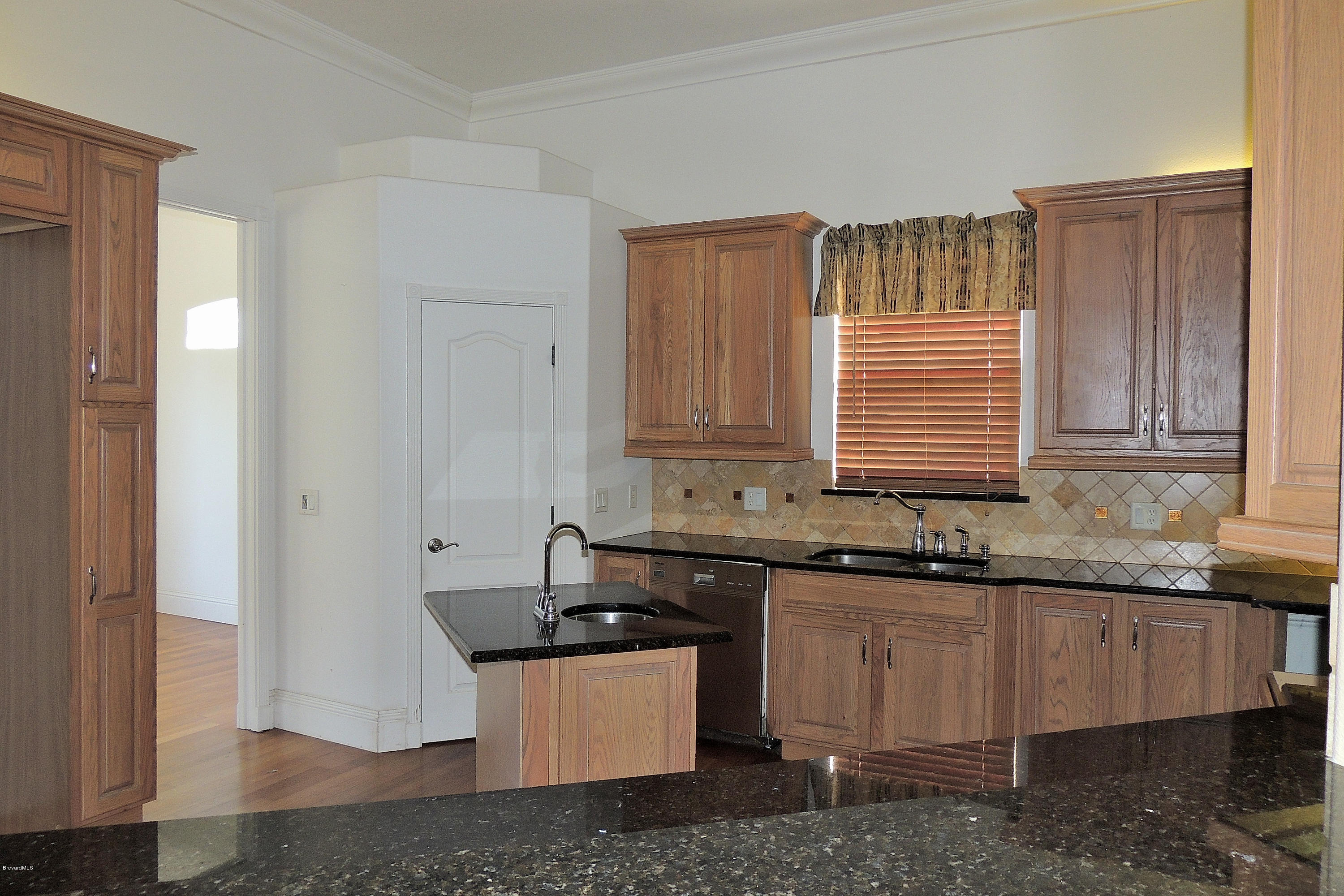 1120 Riviera Drive Northeast Palm Bay, FL 32905 - Photo 6 of 44 a kitchen with granite countertop a sink and a stove