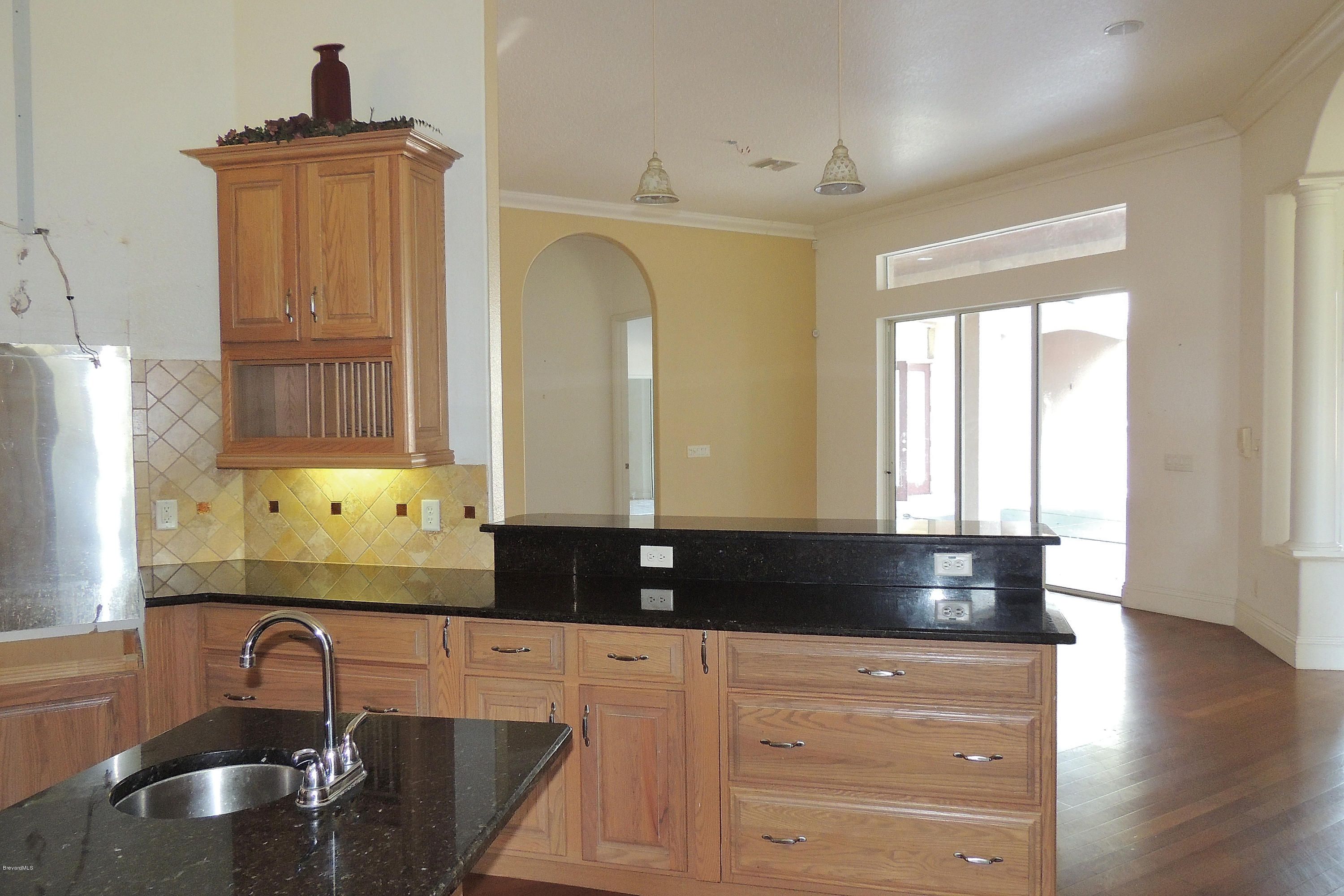 1120 Riviera Drive Northeast Palm Bay, FL 32905 - Photo 10 of 44 a kitchen with granite countertop a sink stainless steel appliances and cabinets