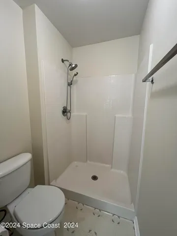 a bathroom with a toilet and shower