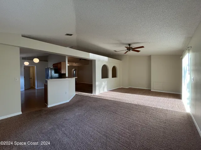 a view of a livingroom with a kitchen
