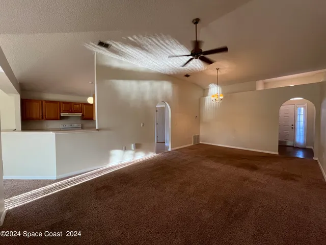a view of a kitchen with a sink and a ceiling fan