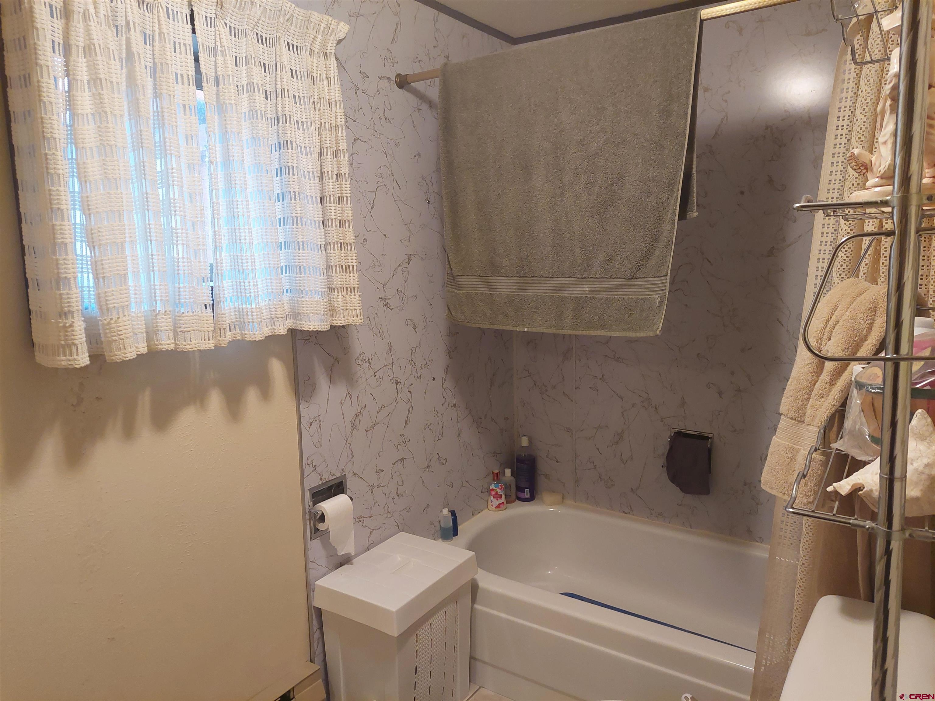 813 Milner Pass Road South Fork, CO 81154 - Photo 17 of 27 a bathroom with a bathtub and shower