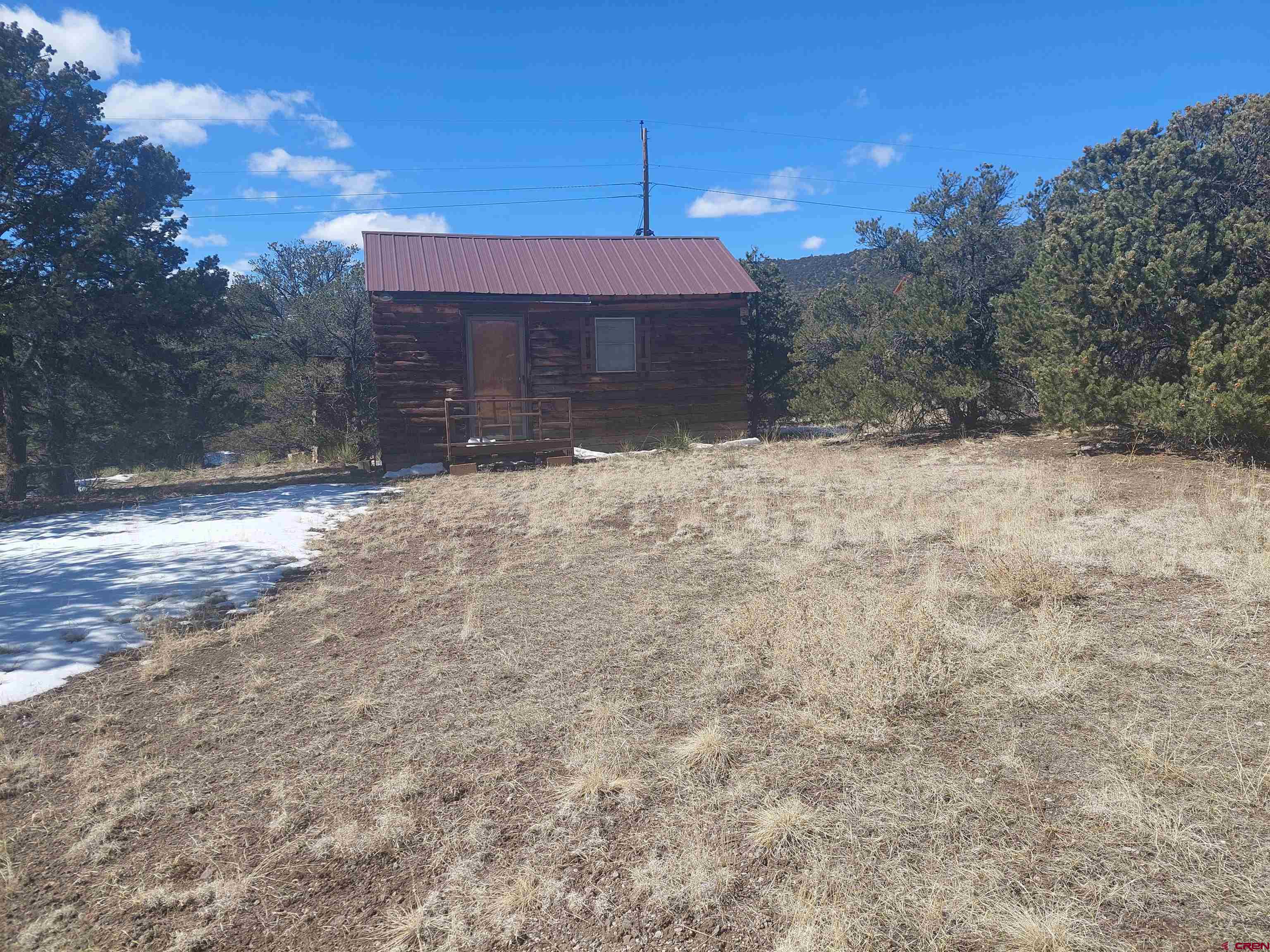 813 Milner Pass Road South Fork, CO 81154 - Photo 23 of 27 a front view of a house with a yard