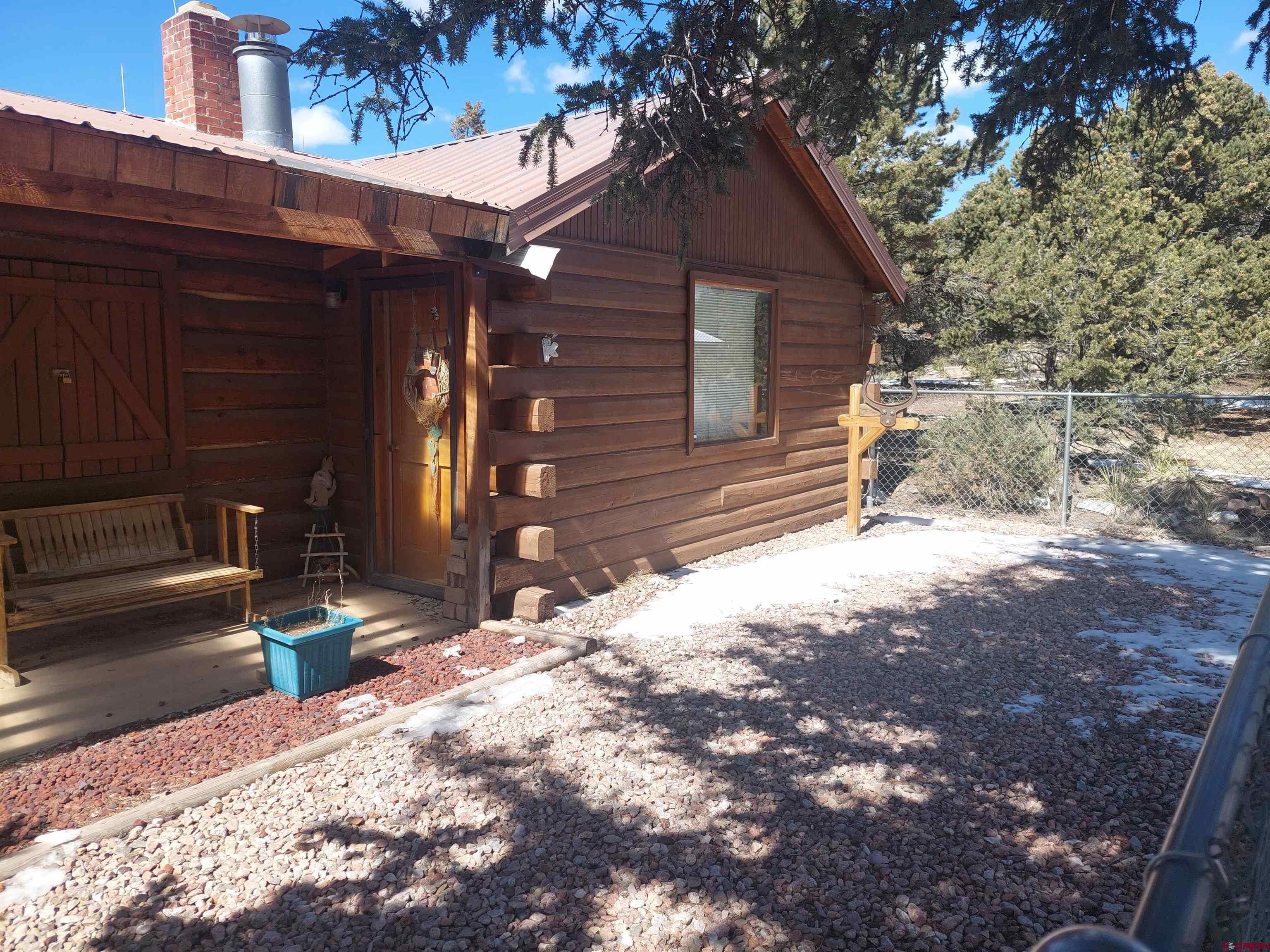 813 Milner Pass Road South Fork, CO 81154 - Photo 3 of 27 a view of a house with a yard