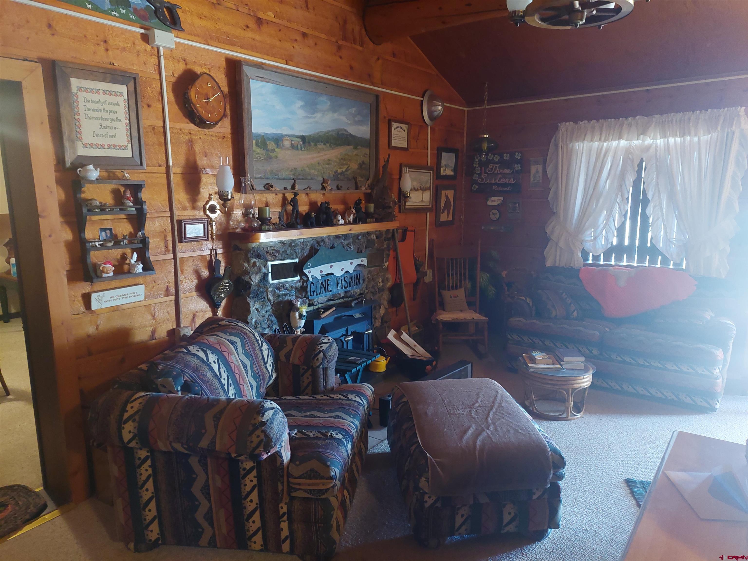 813 Milner Pass Road South Fork, CO 81154 - Photo 6 of 27 a living room with furniture and outdoor space