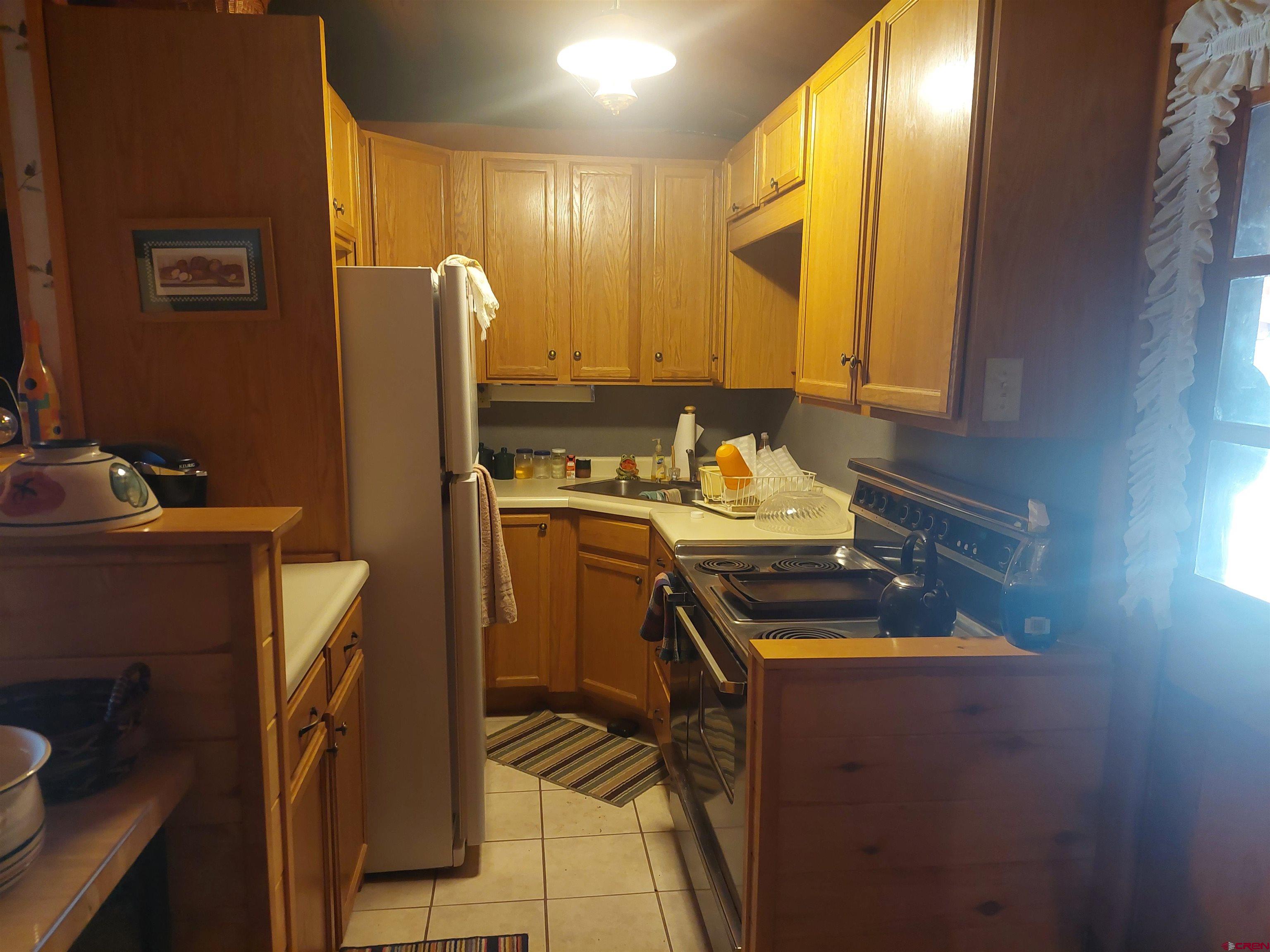813 Milner Pass Road South Fork, CO 81154 - Photo 7 of 27 a kitchen with a sink appliances and cabinets