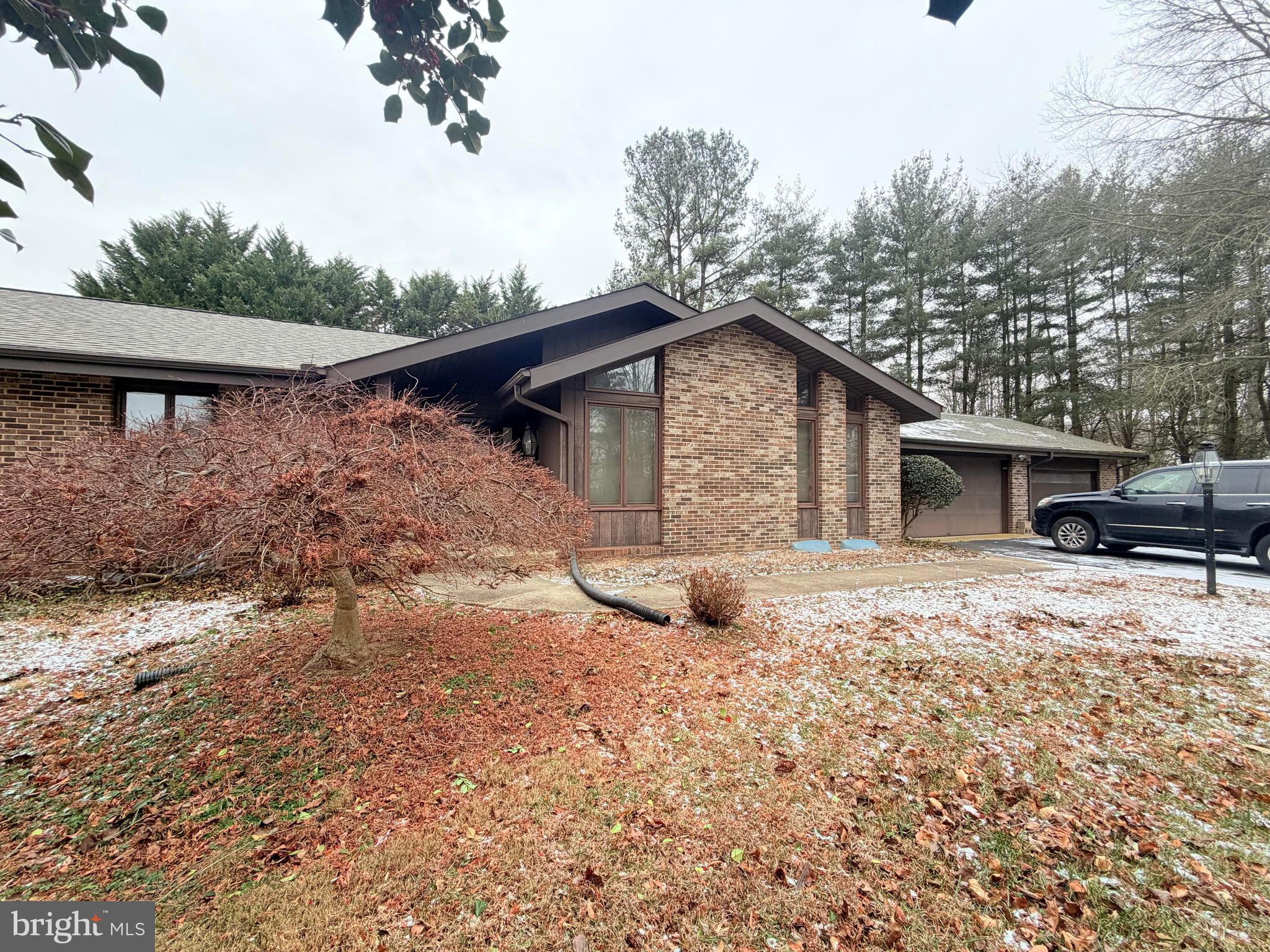 694 Hickory Ridge Road Smyrna, DE 19977 - Photo 2 of 23 a front view of a house with a yard covered in snow