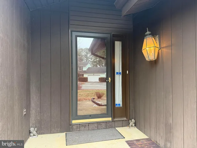 a view of bathroom with a window and a mirror