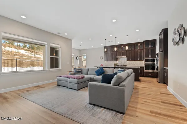 a living room with furniture and view of kitchen