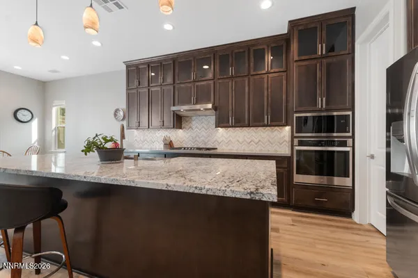 a kitchen with stainless steel appliances granite countertop a refrigerator and a sink