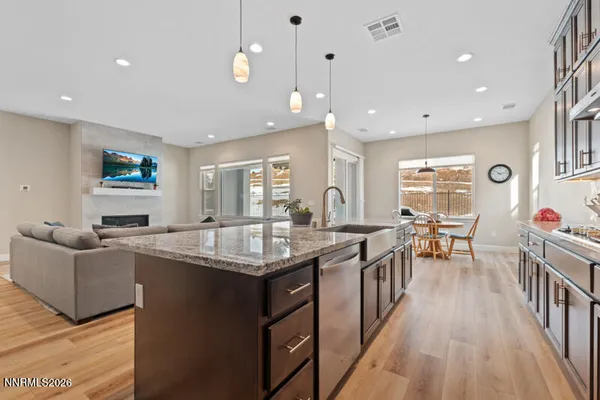 a kitchen with counter top space a sink appliances and living room