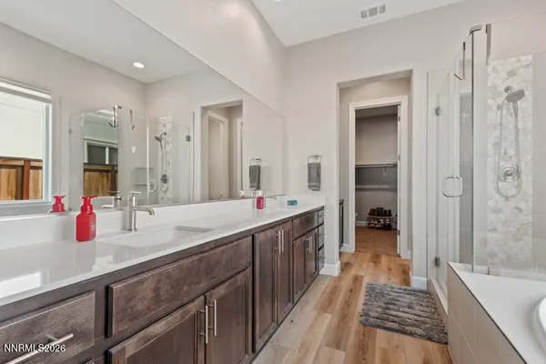 a bathroom with a tub sink and mirror