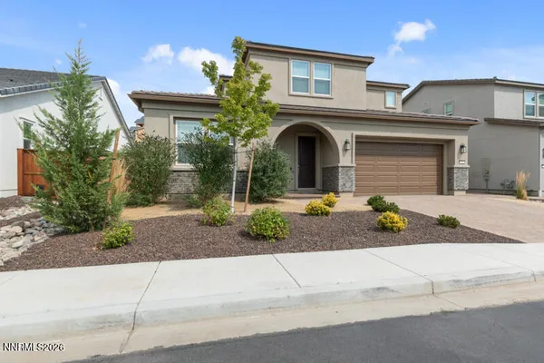 a front view of a house with a yard and garage
