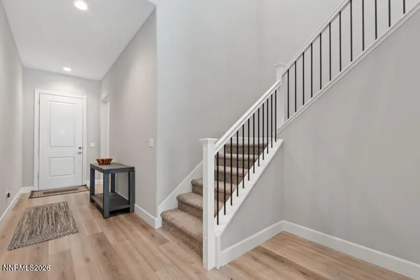 a view of hallway with wooden floor and stairs